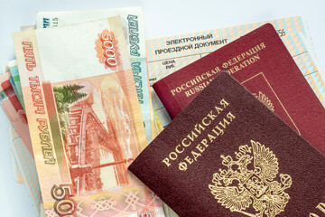 Ruble banknotes in cash and passports of Russian citizen are on train tickets