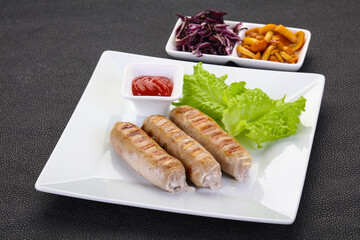 Grilled sausages served mushrooms and cabbage