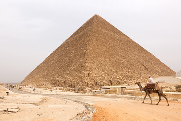 Fototapeta na wymiar GIZA, EGYPT, APRIL 20: Tourists visits the Great Pyramid at Giza complex, Cairo, Egypt on April 20, 2018