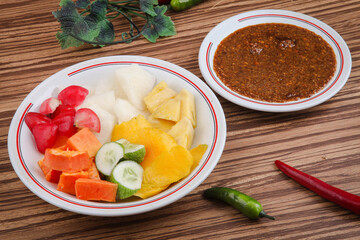 Rujak Buah or Rujak is a traditional Indonesian food, from fruit that is cut into pieces with brown sugar sauce and peanuts as a companion.