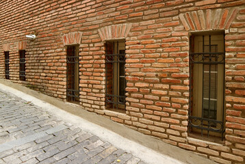 Row of beautiful windows on the old brick wall