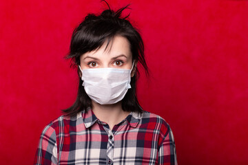 girl in a medical mask, virus protection, pandemic, red background