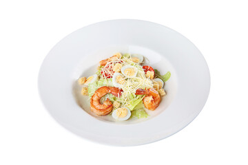 Caesar salad with prawns on a white plate. An isolated object.Top view.