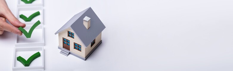 Check Mark Sign Near The House Model