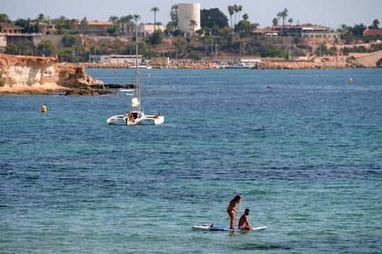 People relax on the Costa Blanca in Orihuela Costa. Spain
