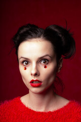 beautiful woman in red with rhinestones on her face