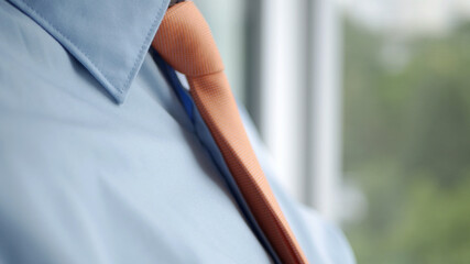 Elegant Businessman Image Wearing a Blue Shirt and Orange Tie 