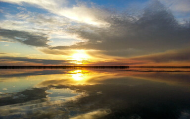 beautiful sunset on the background of the lake.