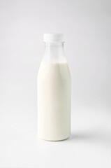 food photography of clean white sterile plastic bottle of natural dairy product close-up on a light gray background isolated