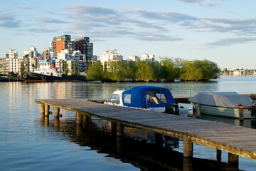 Boats and calm water at the lake on a summer evening in the city in Sweden. Photo taken in Vasteras, Sweden