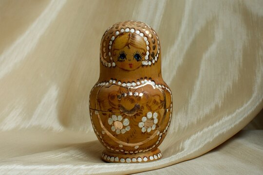 a very beautiful Russian wooden doll painted in gold