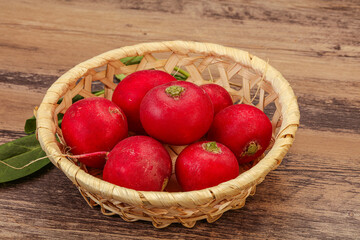 Ripe fresh radish heap over wooden