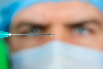 Injection. Doctor with syringe is preparing for injection. Selective focus. Professional doctor...