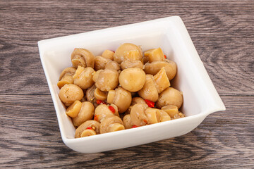Pickled champignons in the bowl