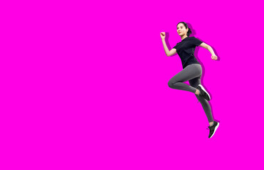 Fototapeta na wymiar Young fitness woman in sportswear jumping in the air. Copy space.