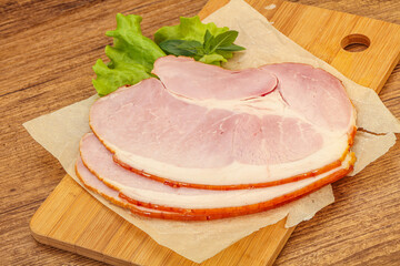 Sliced pork belly over board