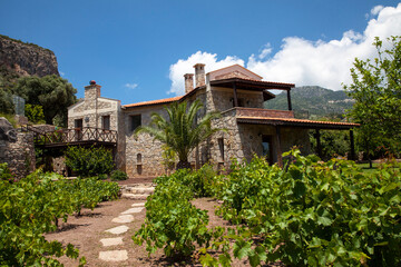 A wonderful stone house in green nature, Beautiful house view in the garden with blue sky and mountains.