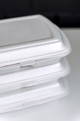 Styrofoam box for food. Toxic plastic waste. Concept of recycling and environmental conservation.