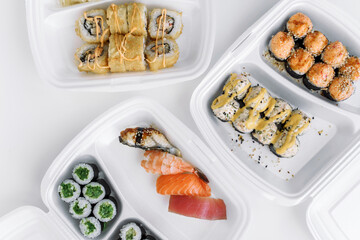 Set of rolls and sushi in a plastic box close up. Delivery service consept.