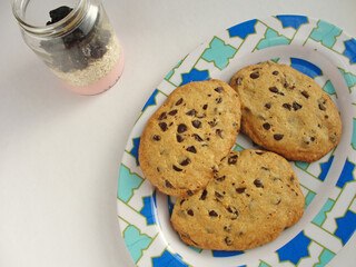 Cookies with chocolate chips on plate with with background