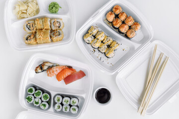 Set of rolls and sushi in a plastic box close up. Delivery service consept.