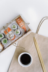 Sushi and rolls delivery service consept on white background (template, open space).
