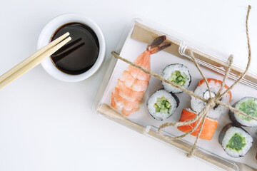 Sushi and rolls delivery service consept on white background (template, open space, top view).