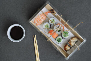 Sushi and rolls delivery service consept on dark  background (template, open space, top view).