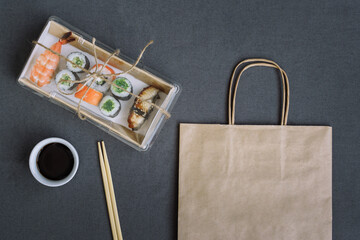 Sushi and rolls delivery service consept on dark  background (template, open space, top view).