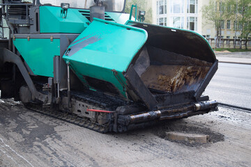 Fototapeta na wymiar Repair of roads. Laying asphalt with a roller.