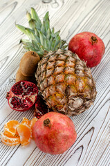 tropical fruits on white wood background