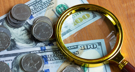 Magnifying glass on money background, business concept