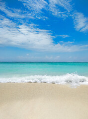 Beautiful beach with white sand, turquoise ocean water and blue sky with clouds in sunny day