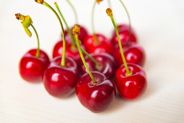 Ripe cherries on wooden surface