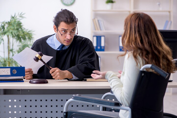 Injured woman and male judge in the courtroom