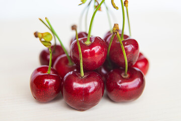Ripe cherries on wooden surface