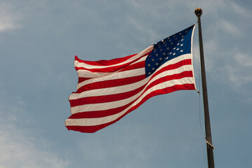 Fototapeta premium United States of America flag with a blue sky. Copy space.
