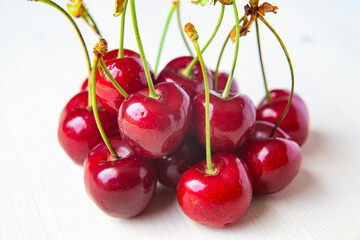Ripe cherries on wooden surface