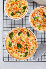 Home made french tart quiche with crayfish and broccoli filled with cream and eggs.