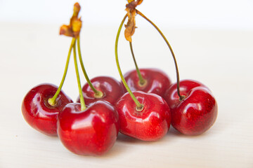 Ripe cherries on wooden surface