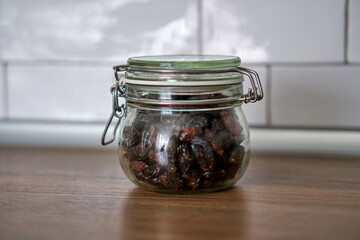  Glass jars with a lid for food on a white shelf. Storage in the kitchen. Containers with bulk products. Transparent container.