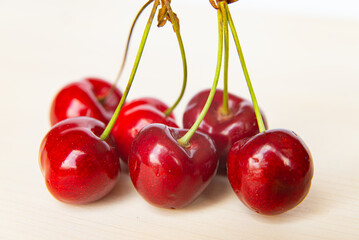 Ripe cherries on wooden surface