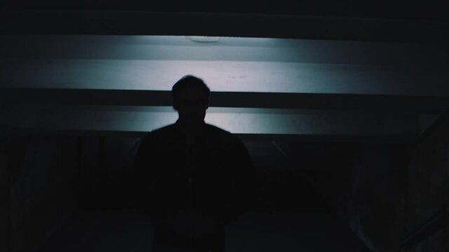 a man walks in the underpass