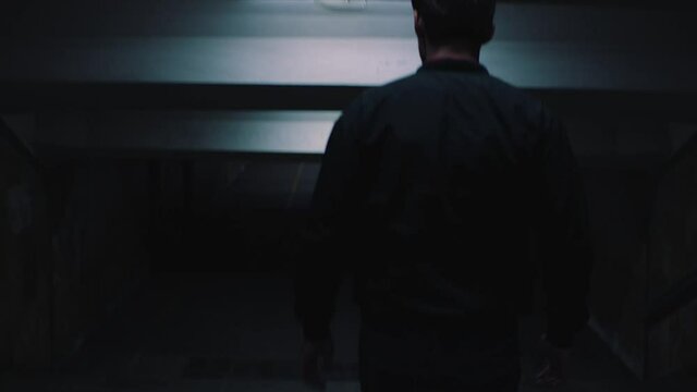 a man walks in the evening underpass