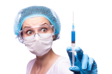 beautiful young girl in medical mask wearing glasses and gloves is holding a syringe