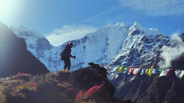 Woman hiker reach the top of mountain landscape and admiring the view of himalaya mountains in Nepal