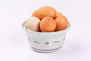 Brown eggs in a white bowl