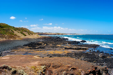 Black rocks on Smith`s beach on Phillip island in Australia