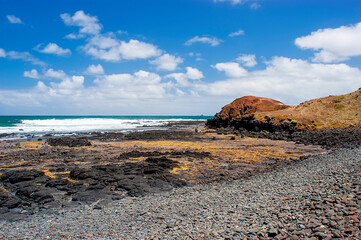 Black rocks on Smith`s beach on Phillip island in Australia