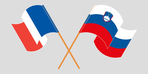 Crossed and waving flags of Slovenia and France